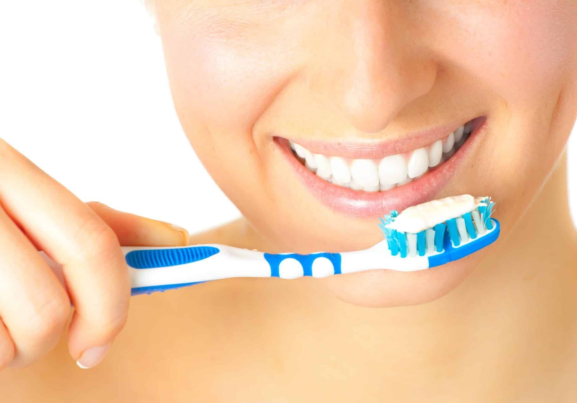 Woman healthy teeth closeup brushing concept